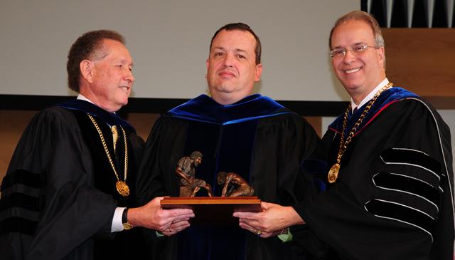 Dr. Joe Early Jr., center, receives the Servant Leadership Award for faculty at Campbellsville University from Dr. Michael V. Carter, president, and Dr. Frank Cheatham, vice president for  academic affairs. (Campbellsville University Photo by Ashley Wilson)